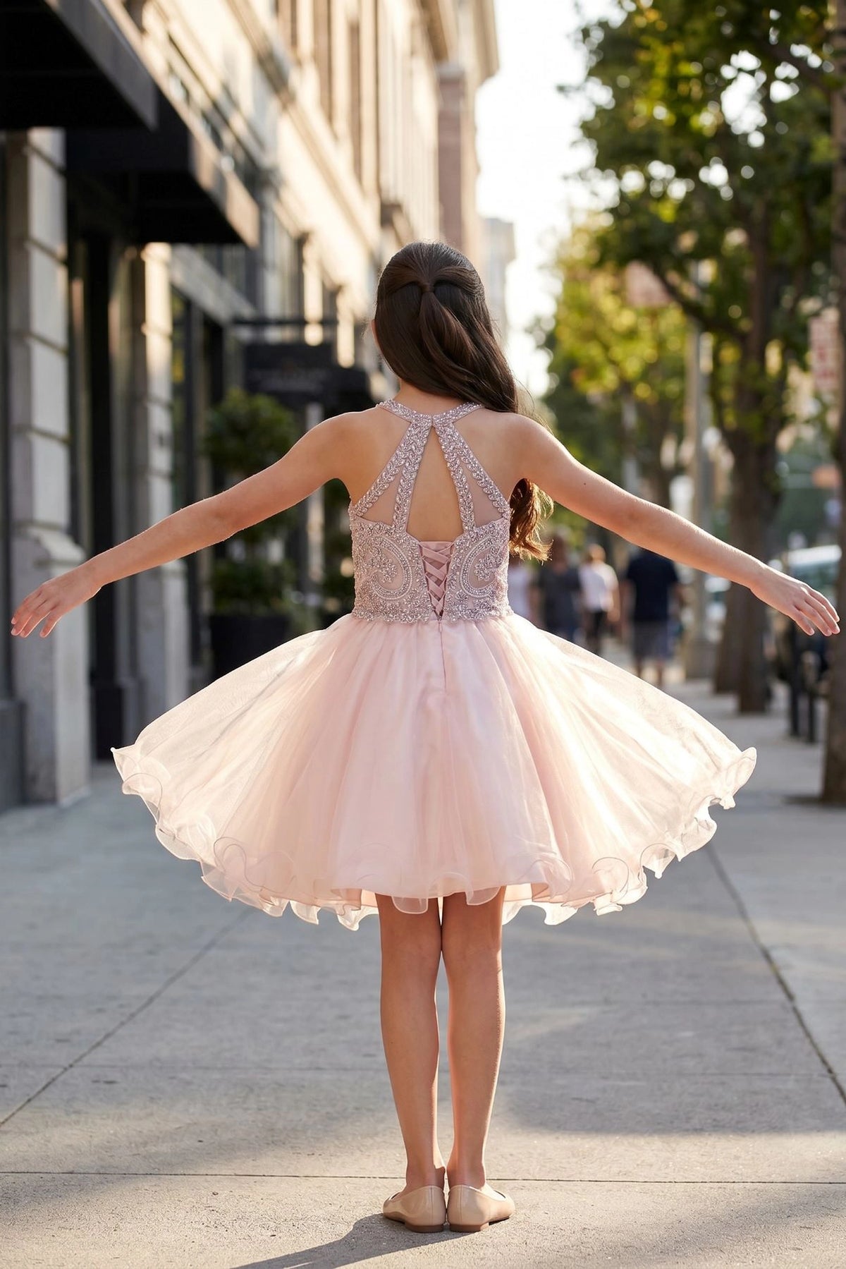 Finished details of crossed halter straps distinguish the Dusty Pink kids party dress.