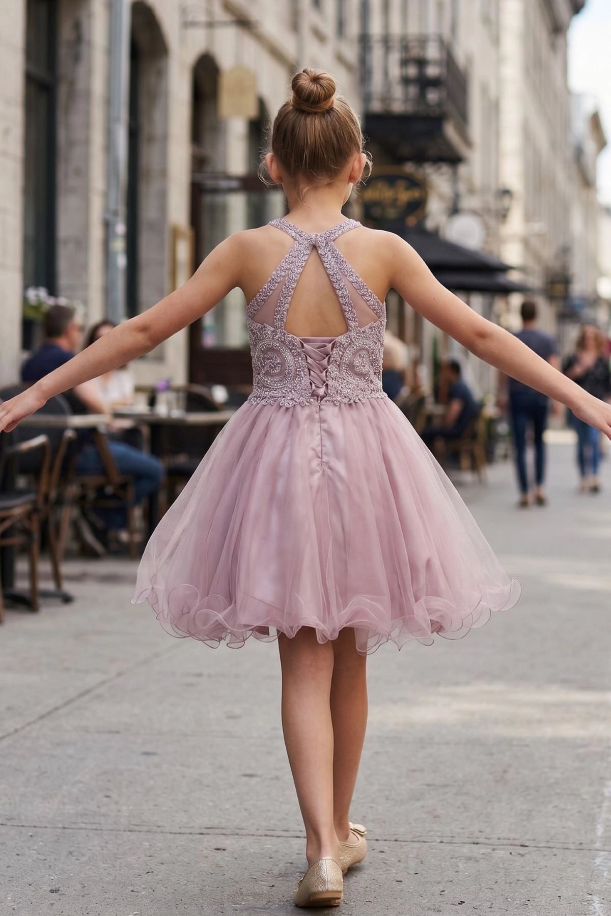 Showcasing with crossed halter straps, this Mauve kids party dress displays elegant detail.