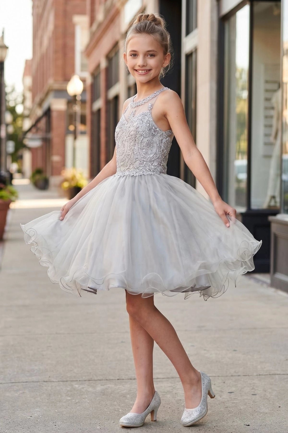 Finished details of crossed halter straps distinguish the Silver kids party dress.