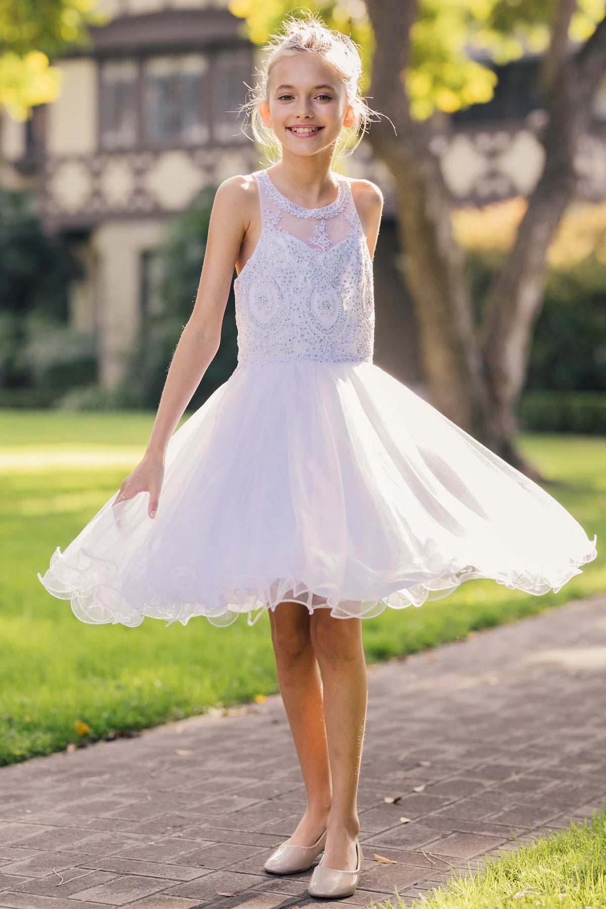 Featuring with a layered tulle skirt, this White kids party dress displays elegant detail.