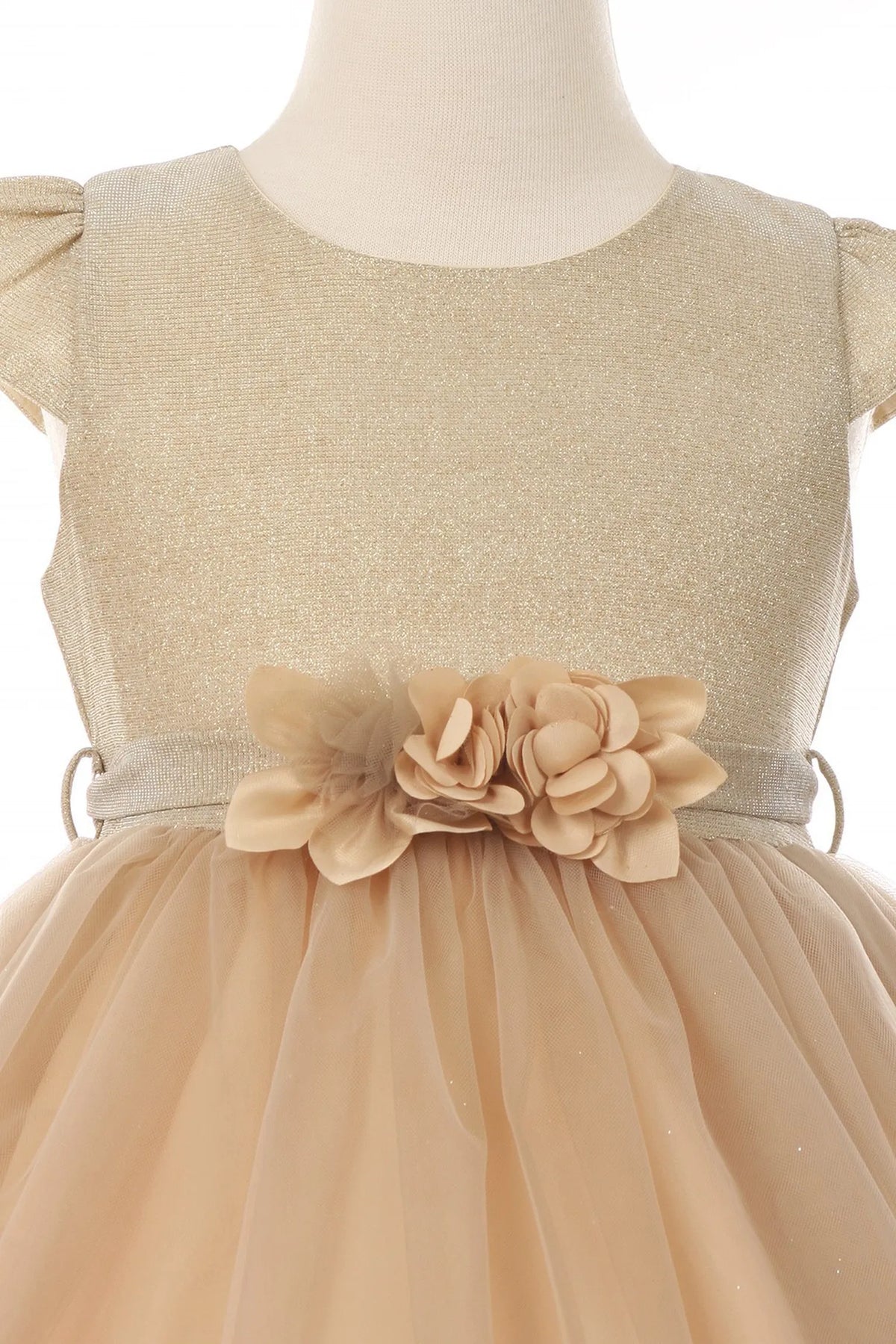 Finished details of flower accents at the waist distinguish the Champagne kids party dress.