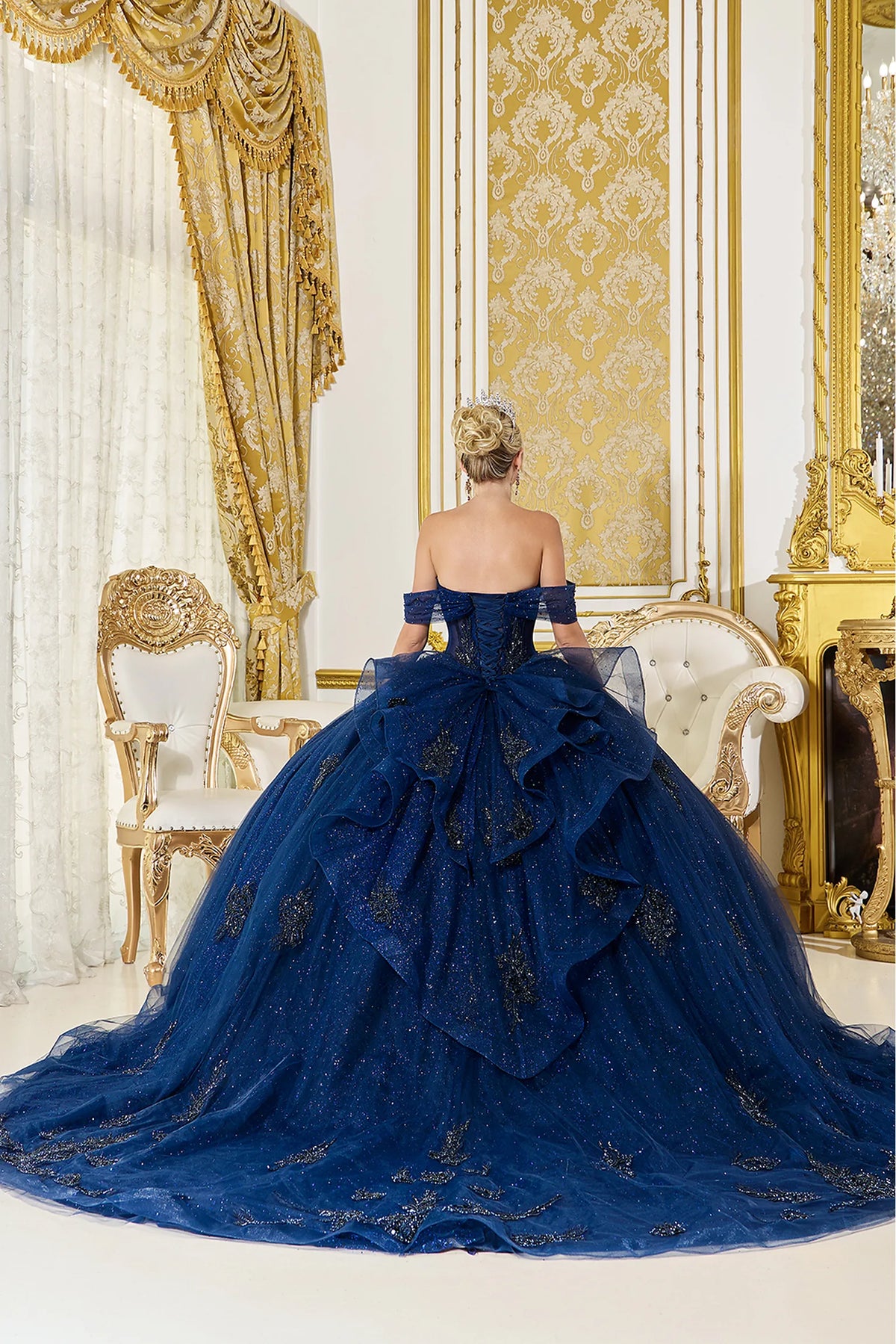 From the back, the Navy quinceañera ball gown reveals its floor-length skirt.