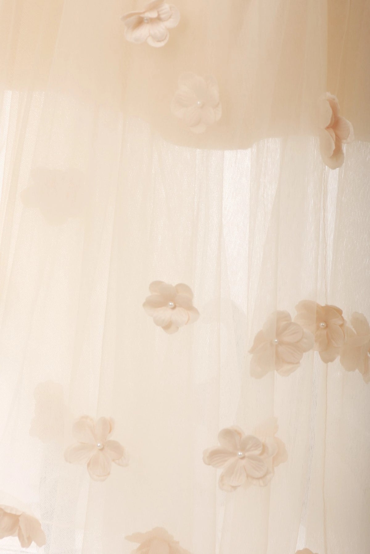 Accented a high-low tulle skirt adds character to this Champagne kids party dress.