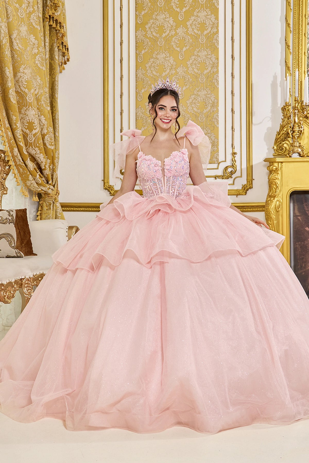 Front view of a Blush quinceañera gown with detachable puff sleeves, beaded corset bodice, and ruffled layered skirt