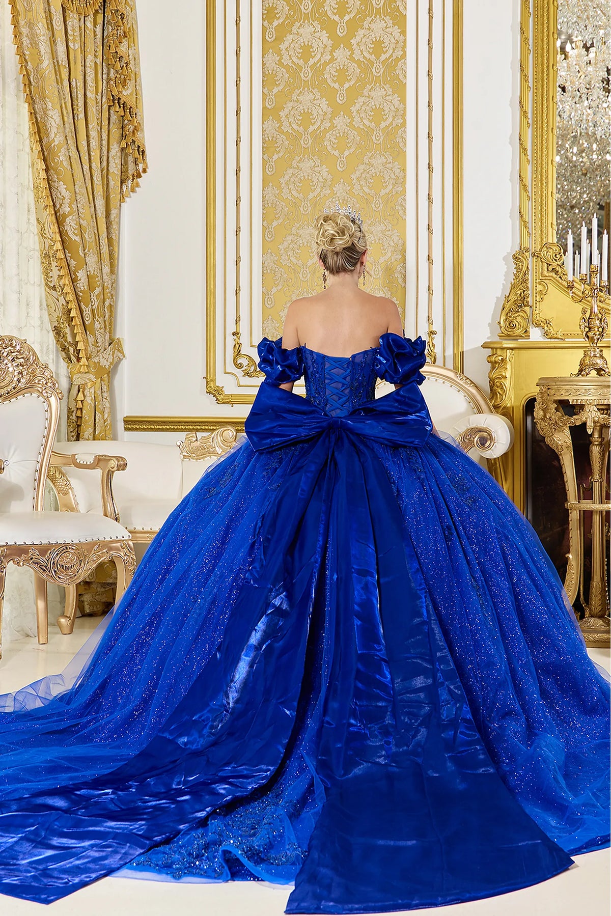 From the back, the Royal Blue quinceañera ball gown reveals its floor-length skirt.