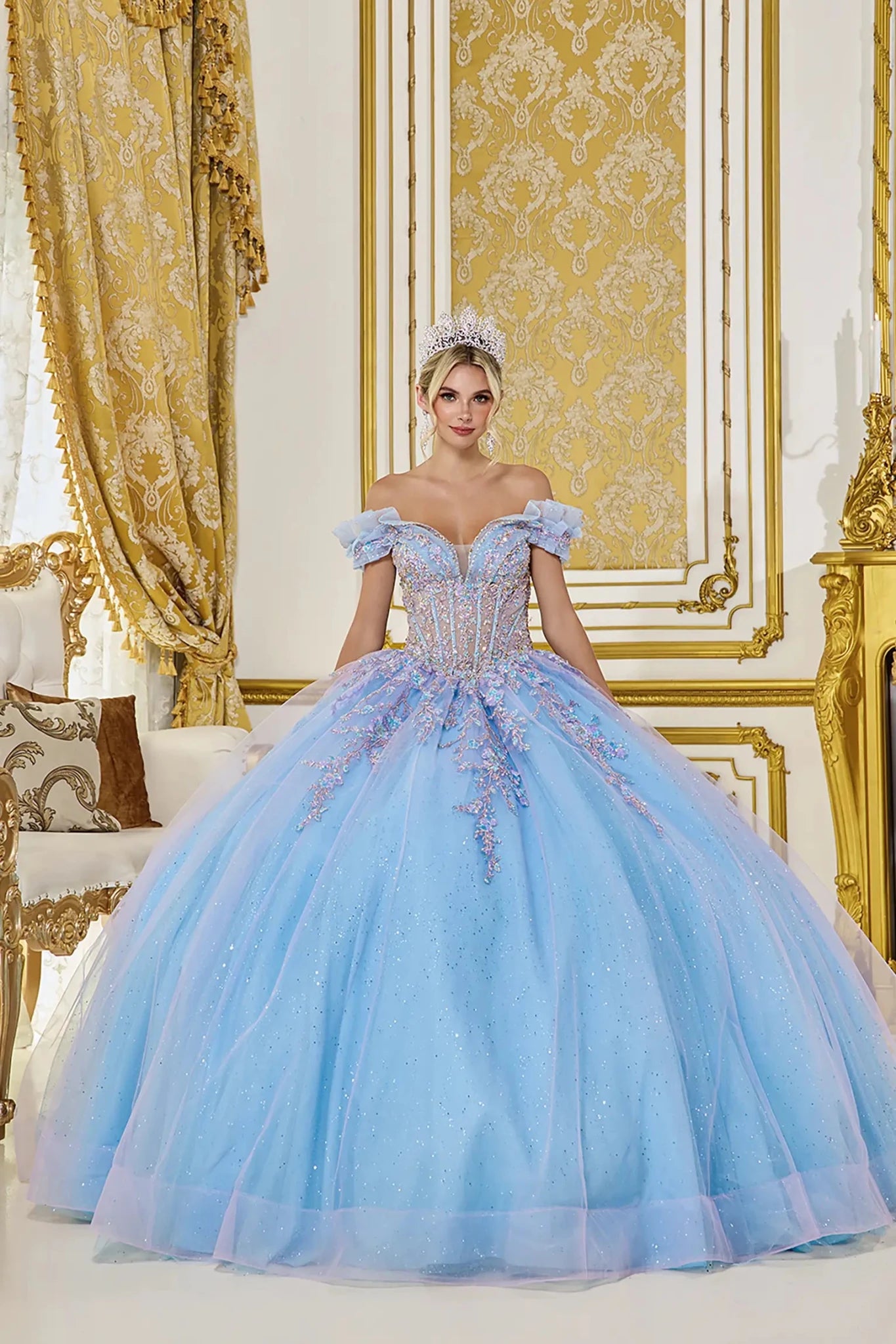 Bahama blue quinceanera ball gown front view featuring off the shoulder ruffle sleeves, sheer corset bodice with iridescent lace appliques, glitter tulle fabric, and full ball gown skirt
