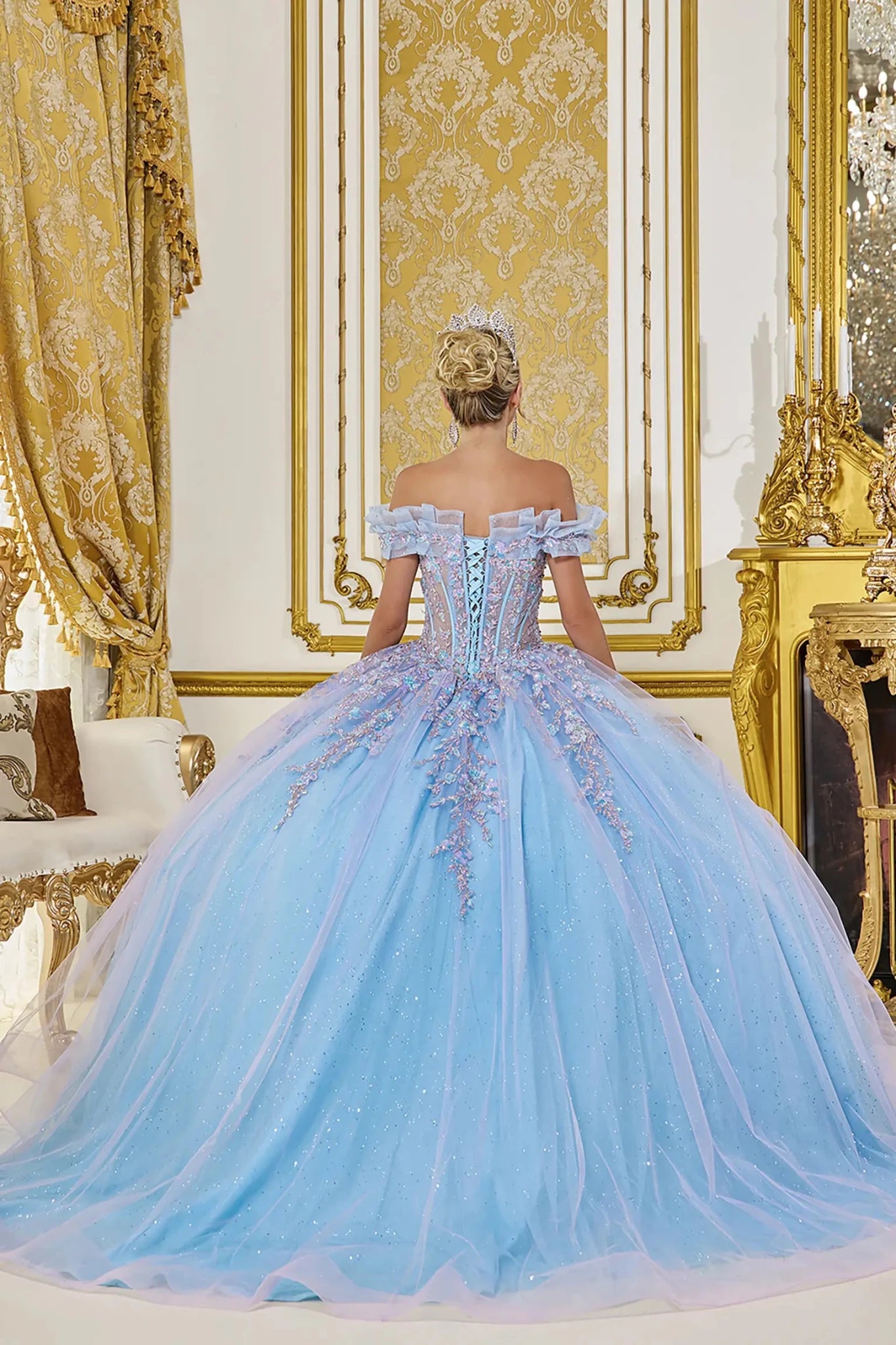 Bahama blue quinceanera ball gown back view showing lace up corset back, layered glitter tulle skirt, and softly flowing train with embroidered applique details