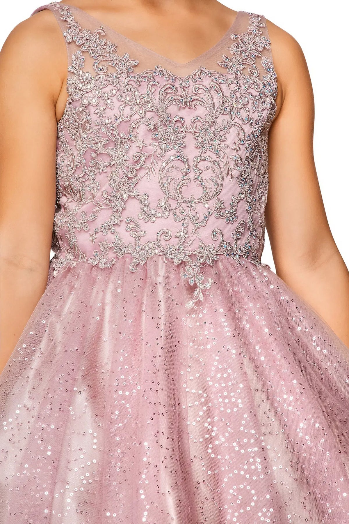 Detailed by a glittered tulle skirt, the Mauve kids party dress reveals its construction.