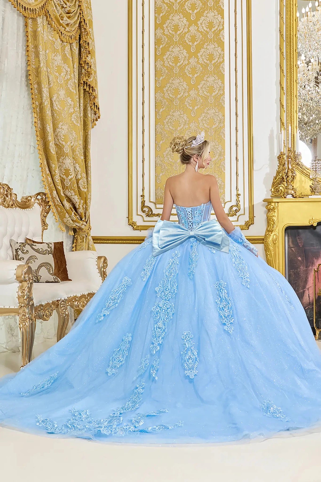 Bahama blue quinceanera ball gown back view showing lace up corset back, oversized satin bow accent, embroidered tulle skirt, and sweeping train