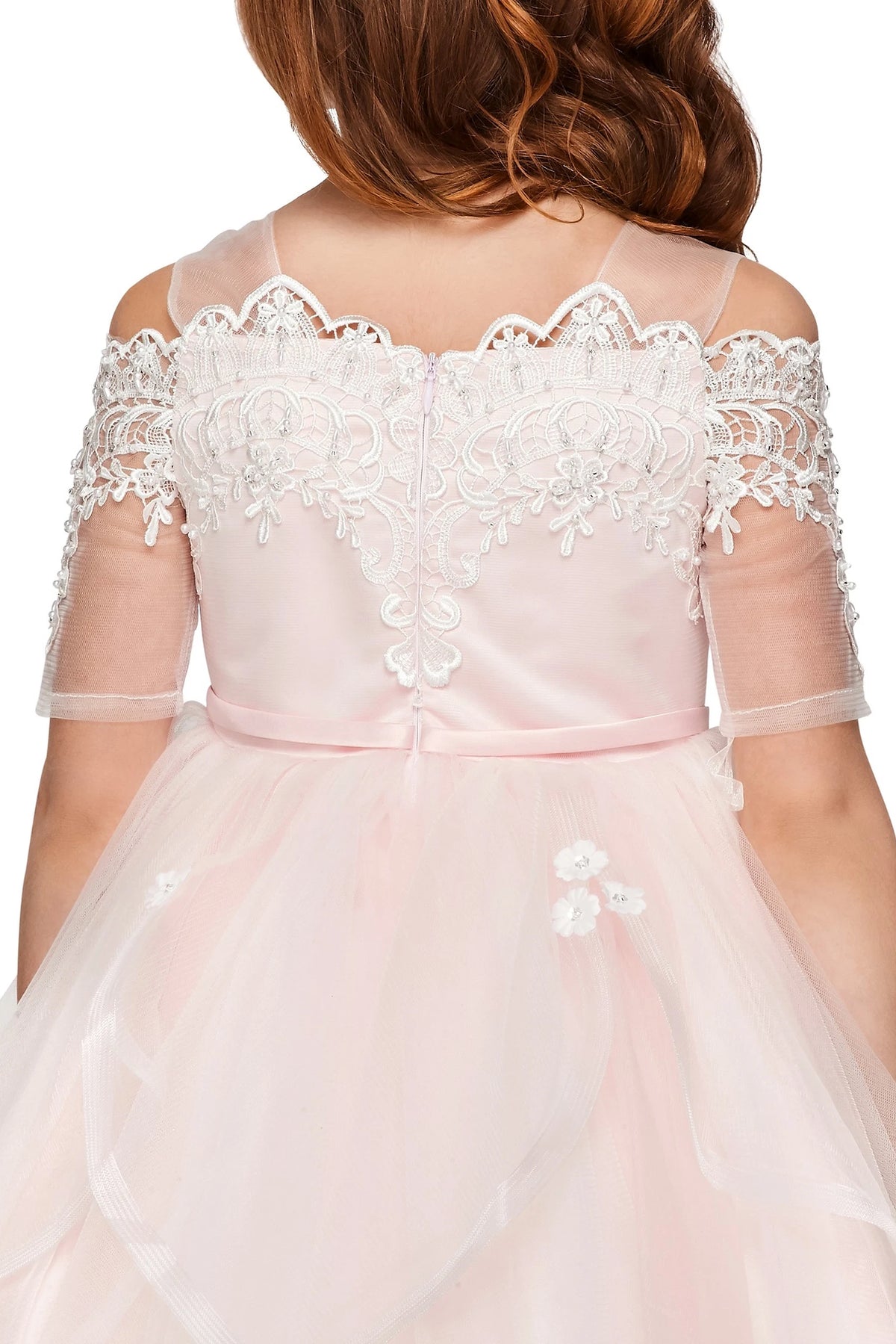A Pink flower girl dress showing scalloped back lace and tied sash.