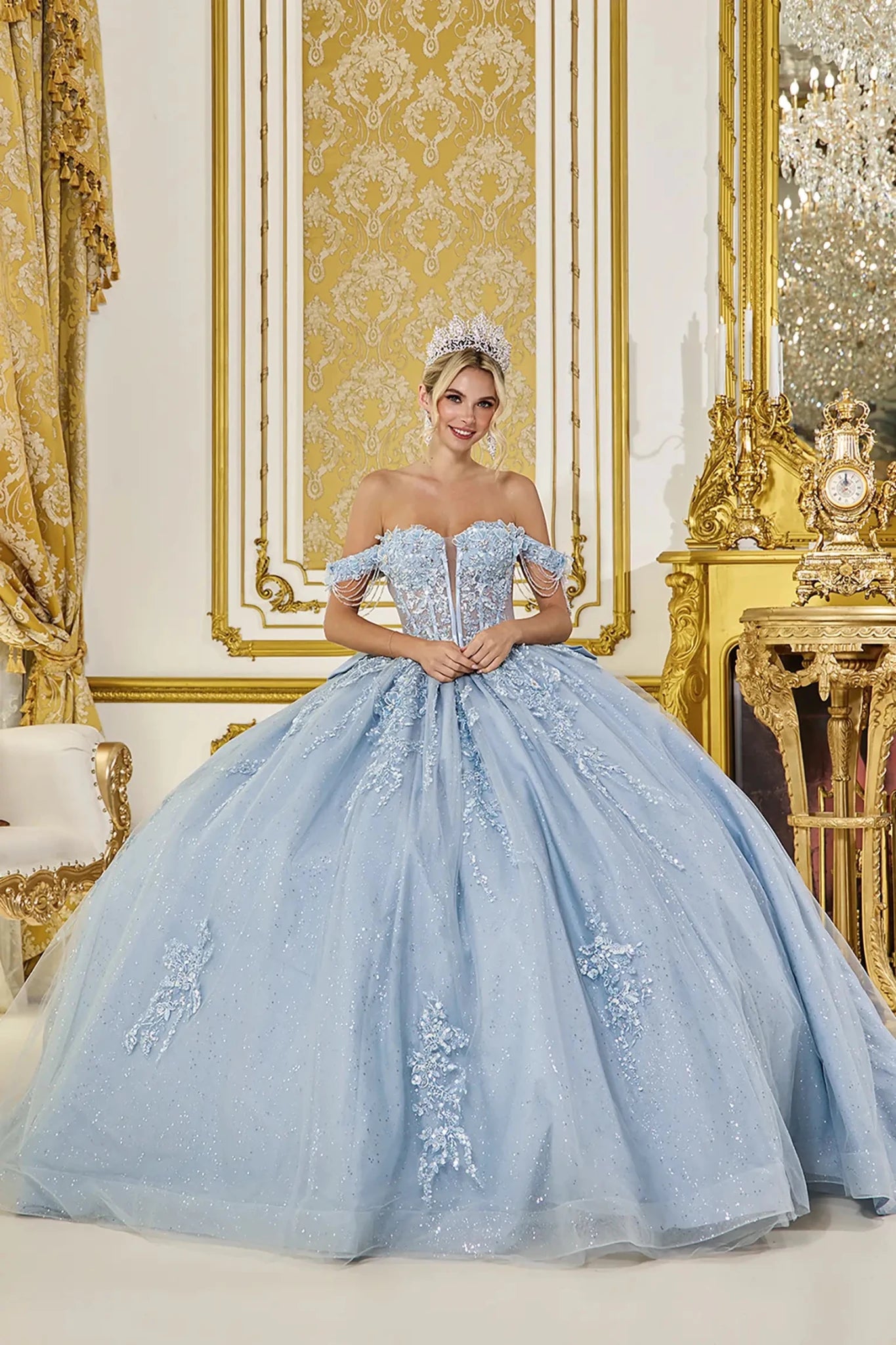 Dusty blue quinceanera ball gown front view featuring off the shoulder sweetheart corset bodice, delicate draped sleeve chains, lace applique detailing, glitter tulle fabric, and full voluminous skirt