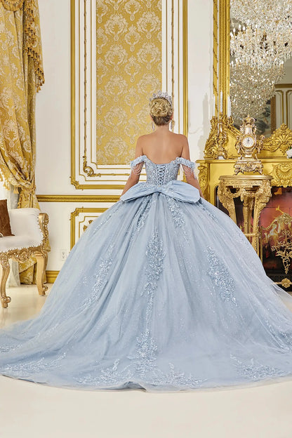Dusty blue quinceanera ball gown back view showing lace up corset back, structured bow detail, embroidered tulle skirt, and flowing train