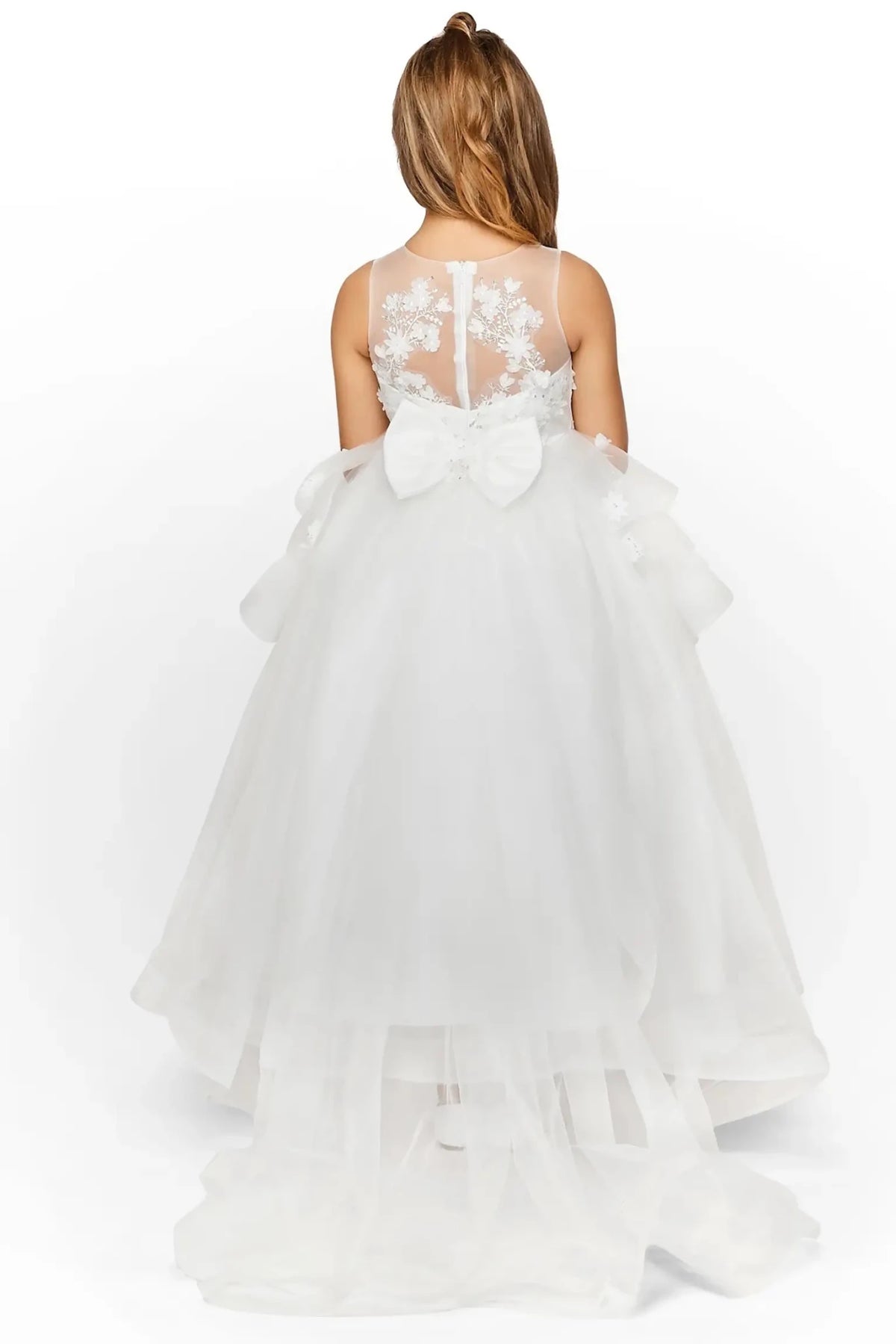 Back view of off-white high-low flower girl dress with lace-up bodice, lace appliqué accents, sequin bead details, and detachable train.