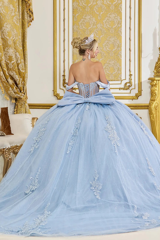 Back view of dusty blue quinceañera ball gown with off-the-shoulder straps, lace-up corset back, oversized satin bow, glitter tulle skirt, and floral lace appliqués