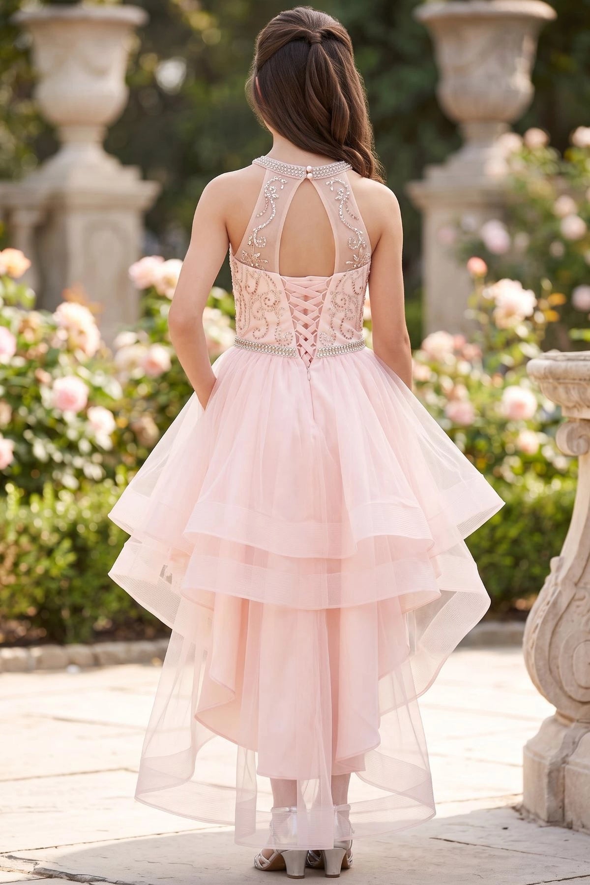Showcasing with a halter back opening and crisscross lacing, this Blush kids party dress displays elegant detail.