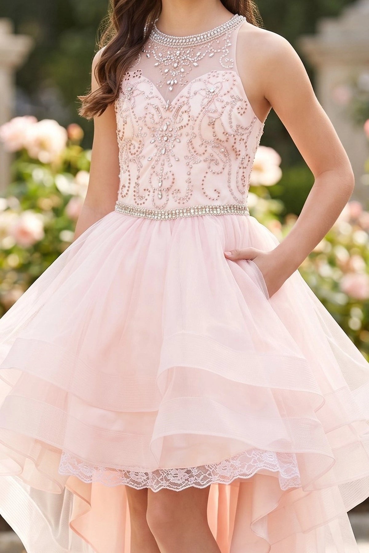 Detailed by a tiered high-low tulle skirt, the Blush kids party dress reveals its construction.