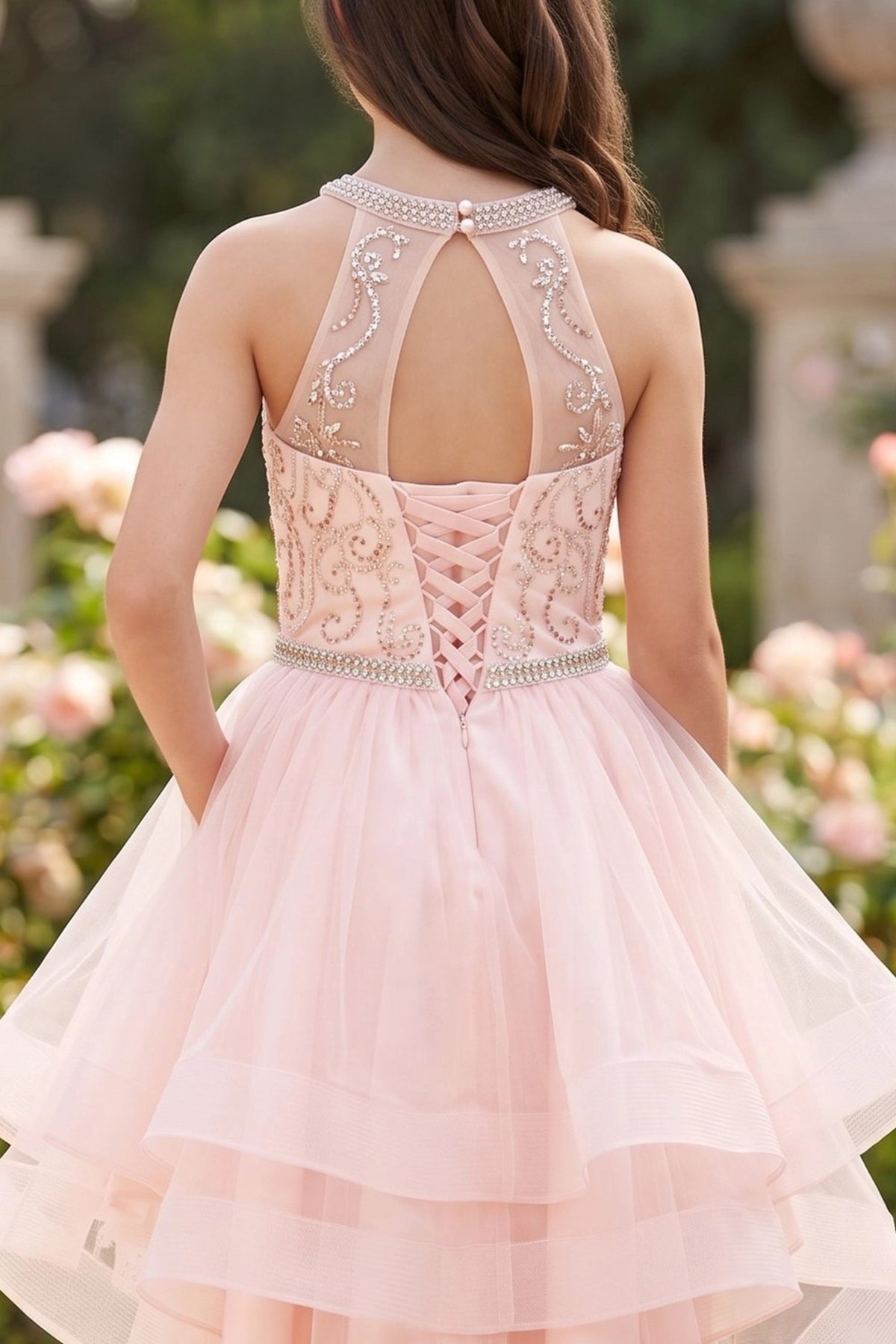 Finished details of a halter back opening and crisscross lacing distinguish the Blush kids party dress.