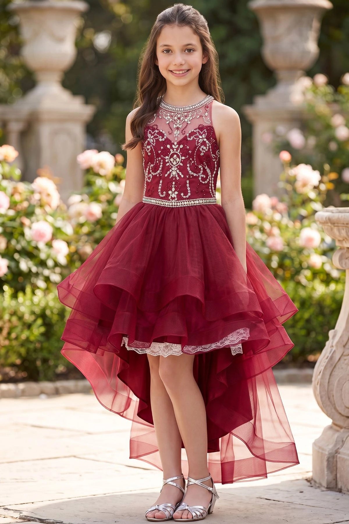 Showcasing with a tiered high-low tulle skirt, this Burgundy kids party dress displays elegant detail.