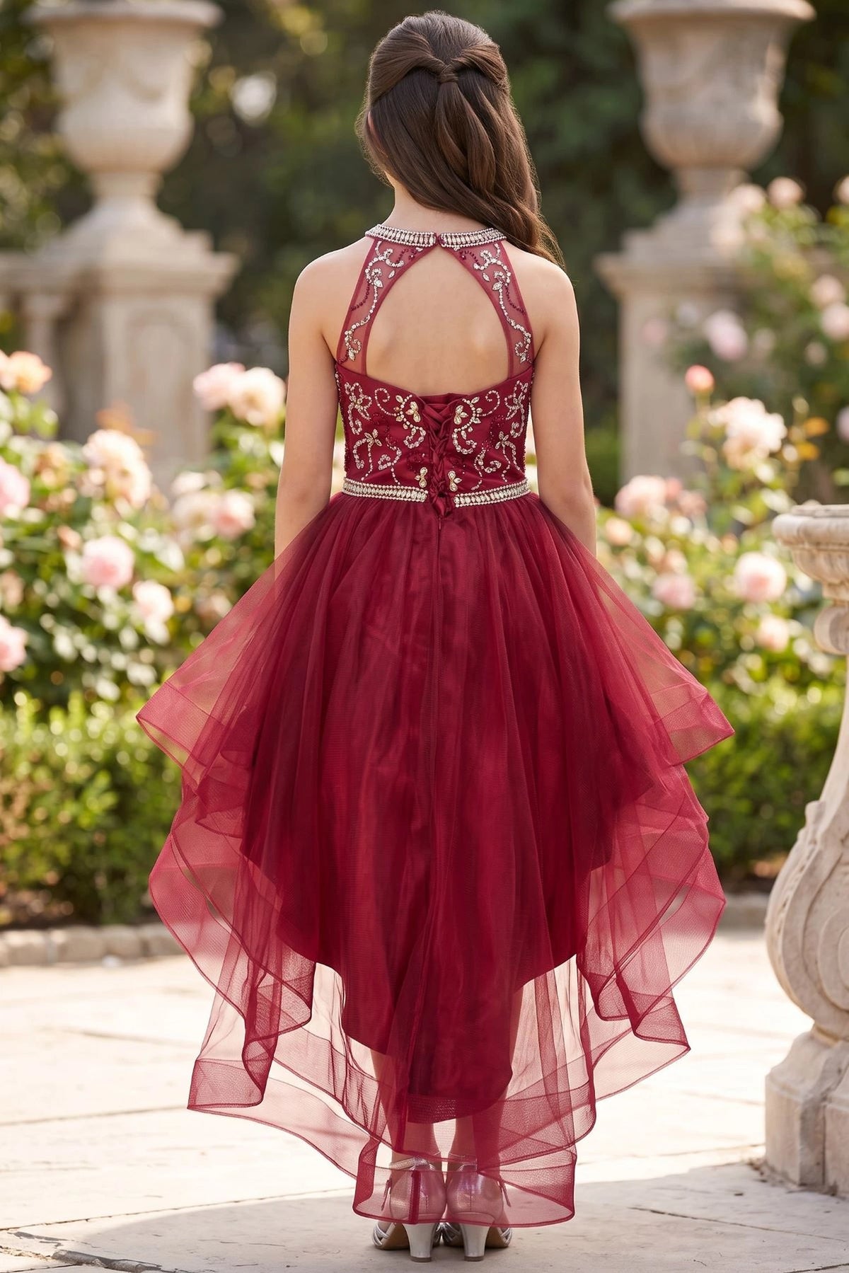 Finished details of a halter back opening and crisscross lacing distinguish the Burgundy kids party dress.