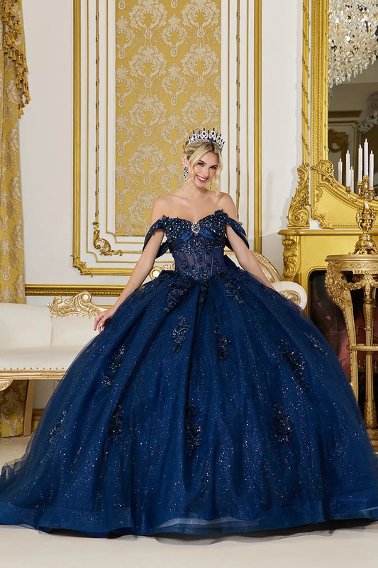Front view of navy blue quinceañera ball gown with off-the-shoulder sweetheart bodice, sheer corset detail, and full glitter tulle skirt with floral embellishments