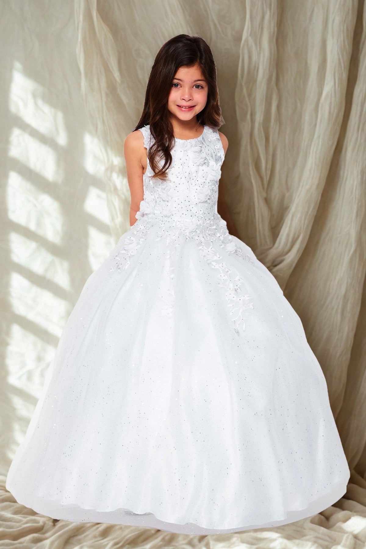 Front view of white mini quince flower girl dress with 3D flowers rhinestones and shiny tulle skirt. Also suitable as a mini quince dress.