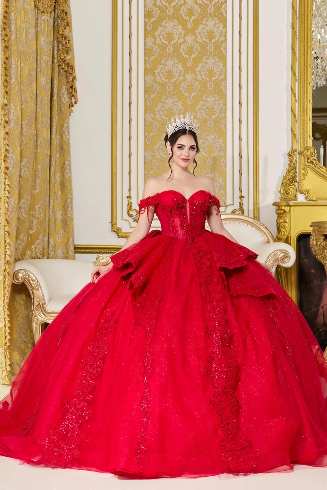 Front view of red quinceañera ball gown with off-the-shoulder straps, sweetheart corset bodice, layered glitter tulle skirt, and ornate lace embroidery panels.