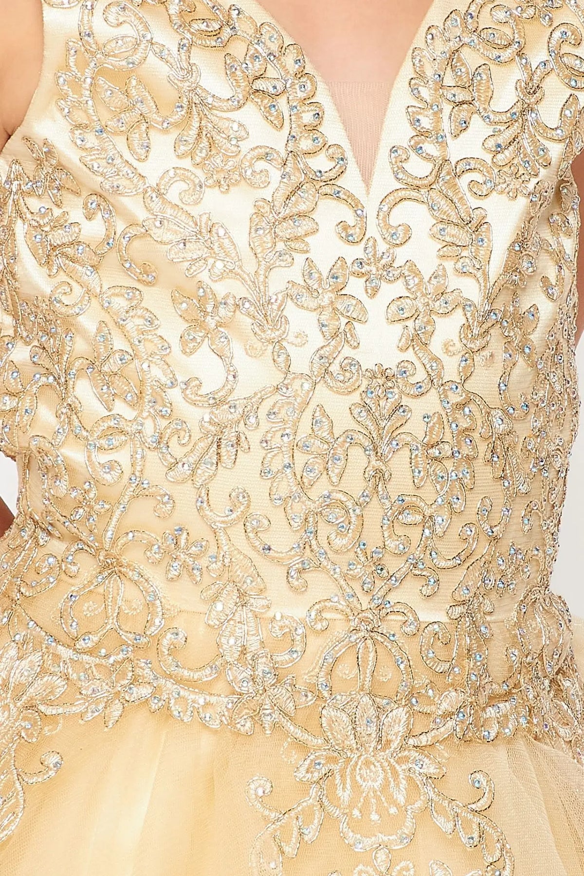 Detailed by contrasting ornamental lace on the bodice, the Champagne kids party dress reveals its construction.