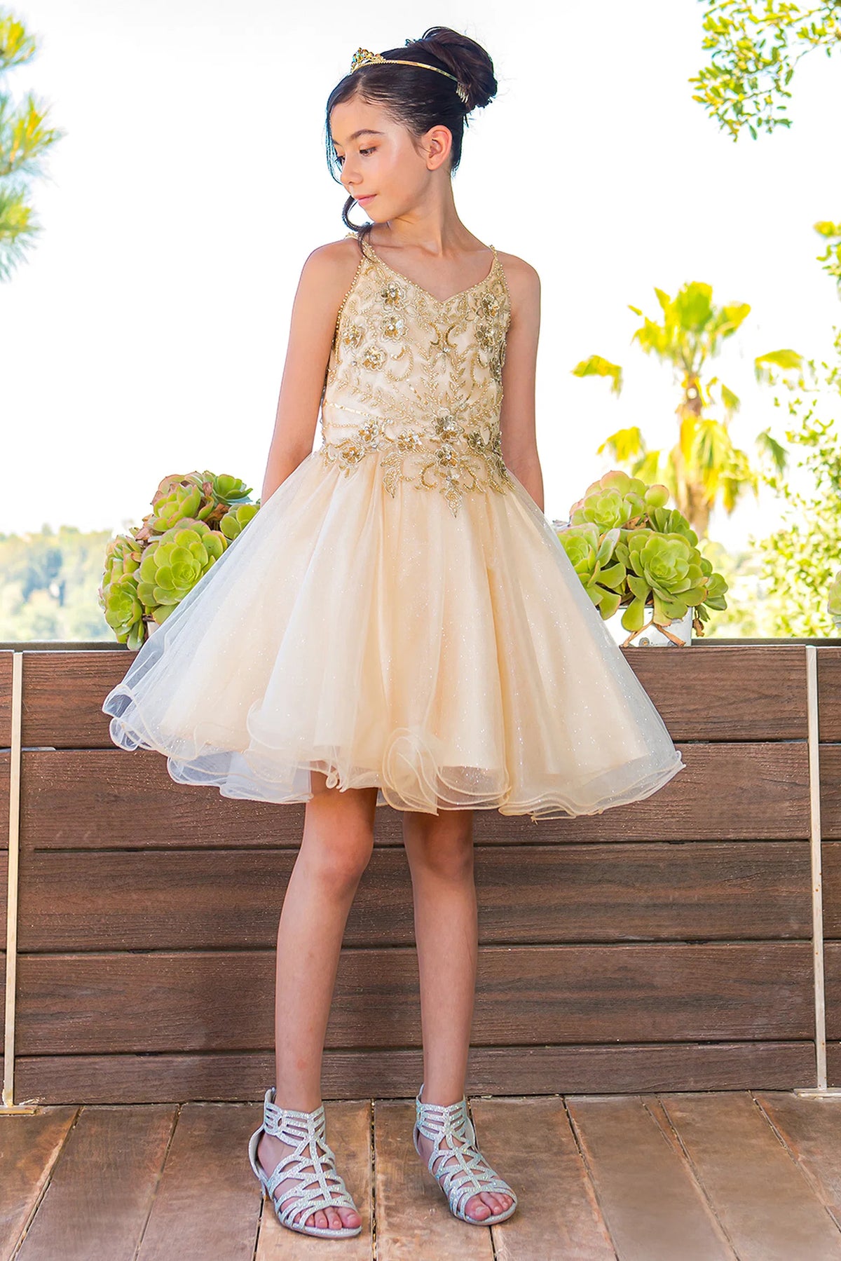 Trimmed by floral beadwork across the bodice, the Champagne kids party dress reveals its construction.