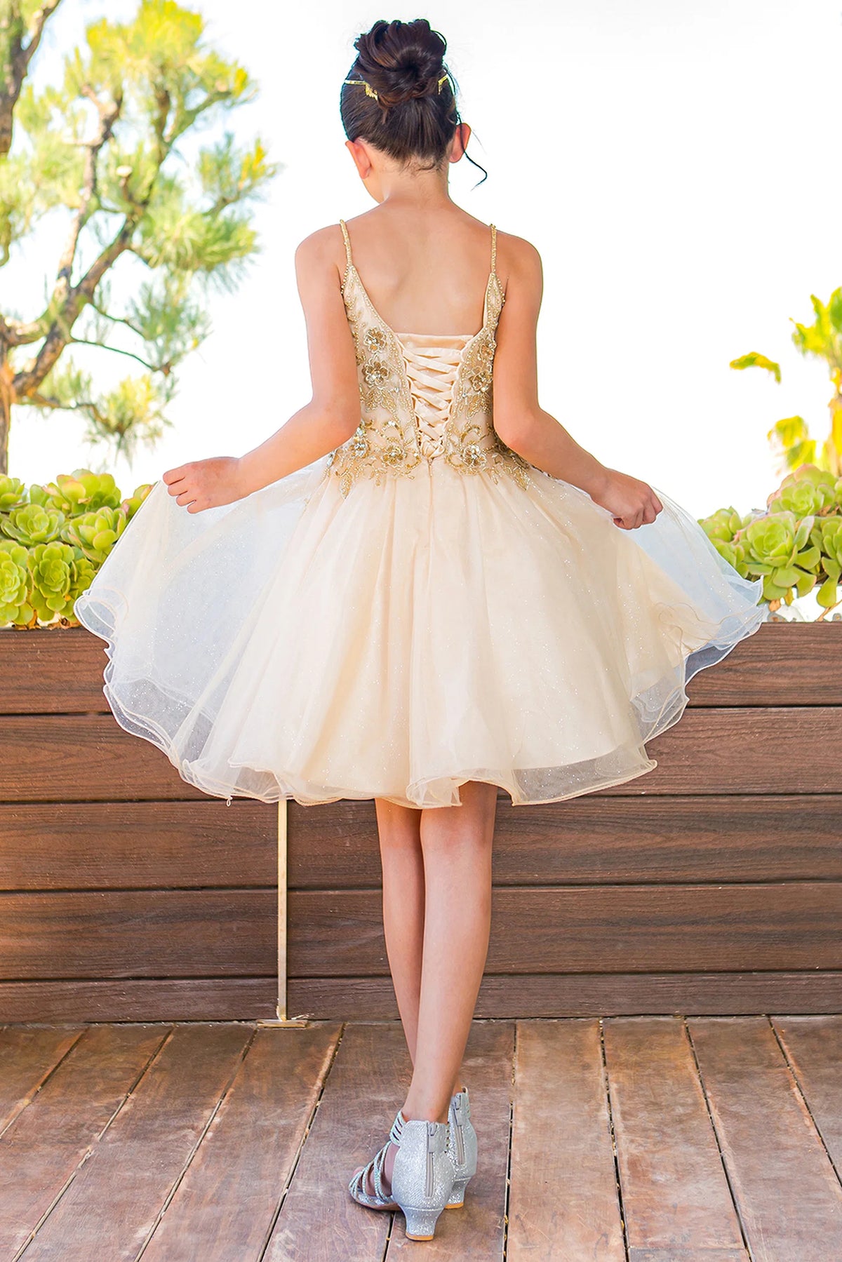 Finished details of crisscross back lacing distinguish the Champagne kids party dress.