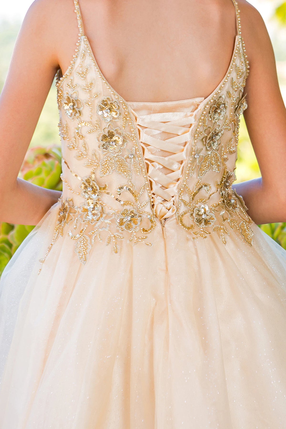 Detailed by crisscross back lacing, the Champagne kids party dress reveals its construction.