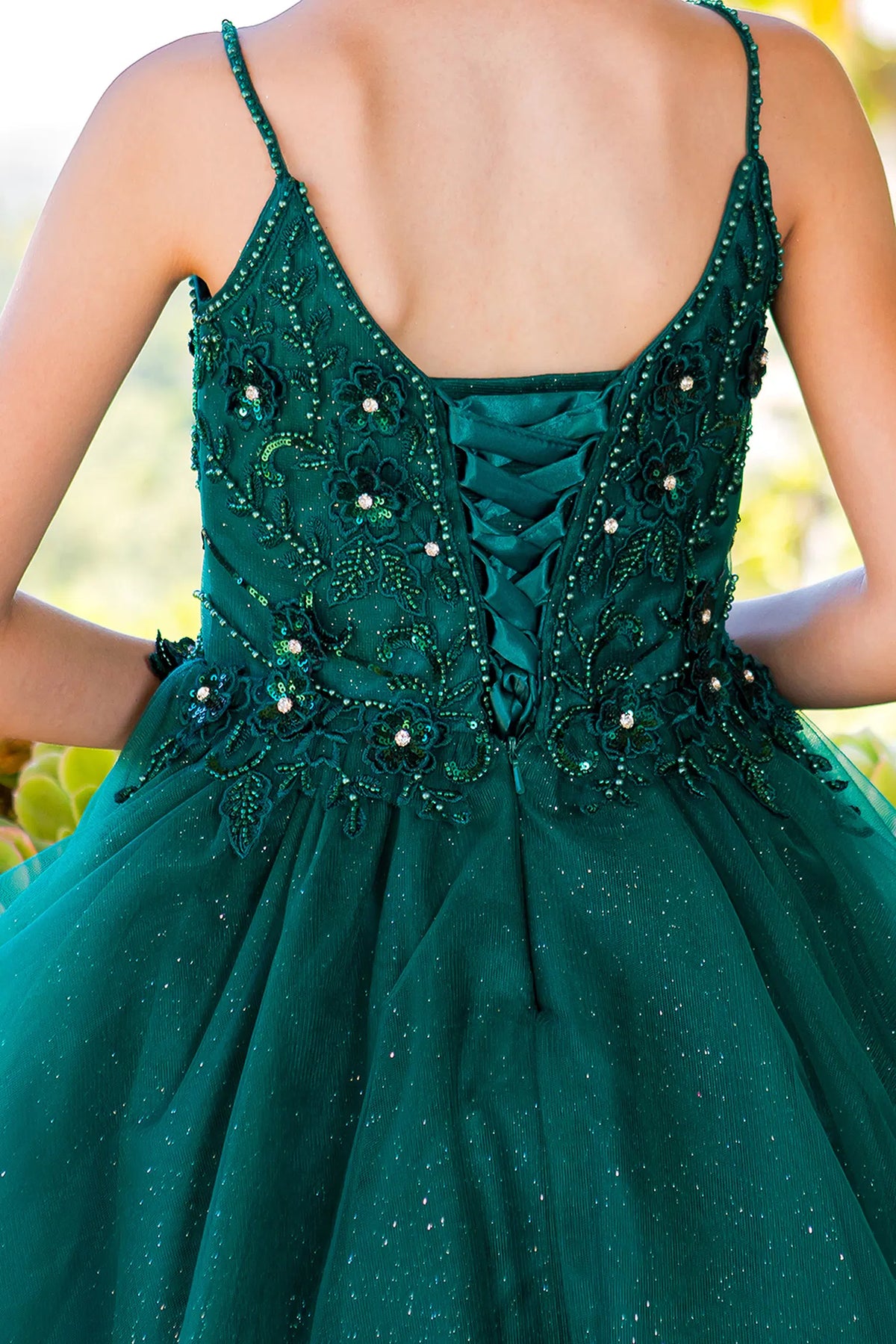 Detailed by crisscross back lacing, the Hunter Green kids party dress reveals its construction.