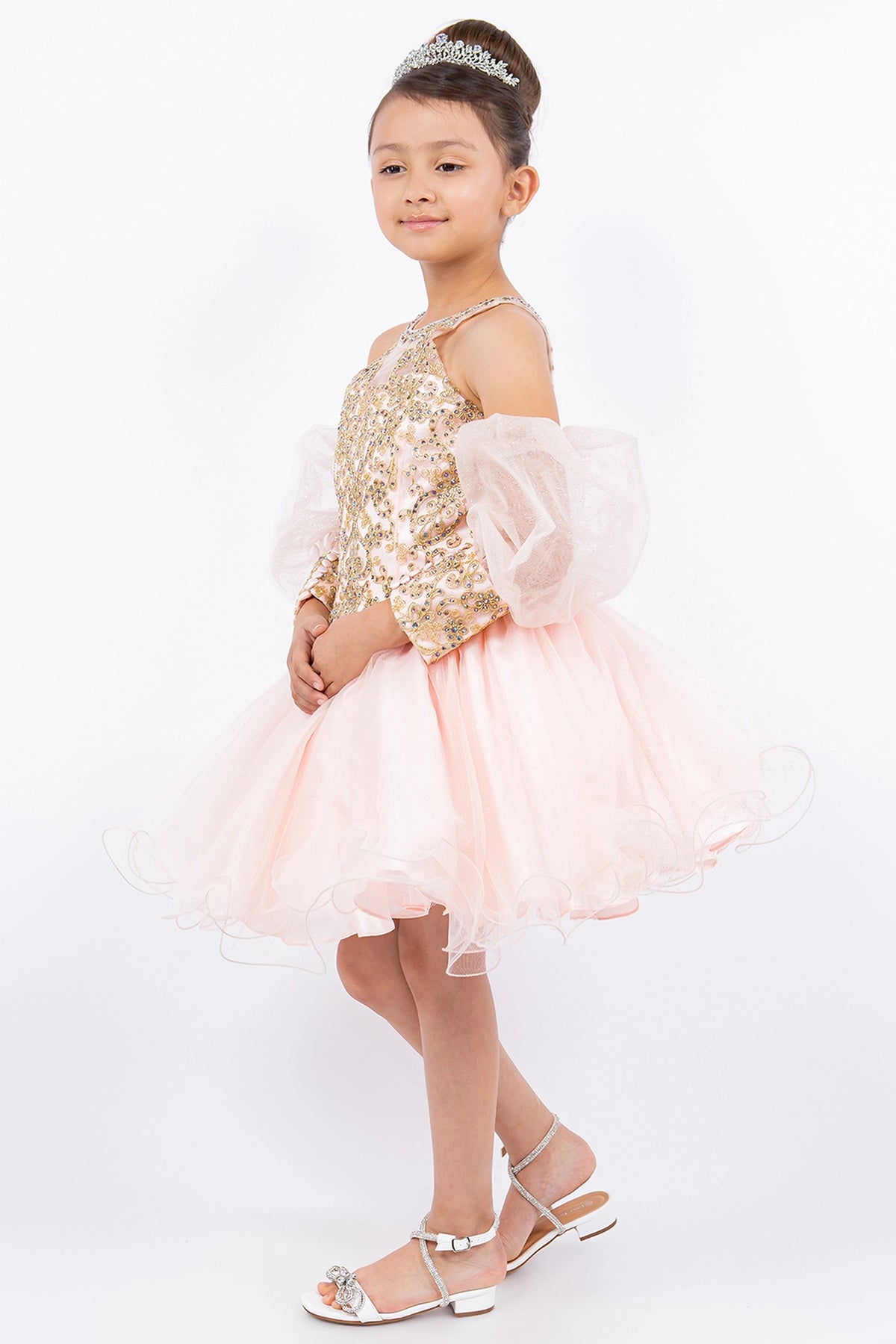 Trimmed by puffed off-shoulder sleeves, the Blush kids party dress reveals its construction.