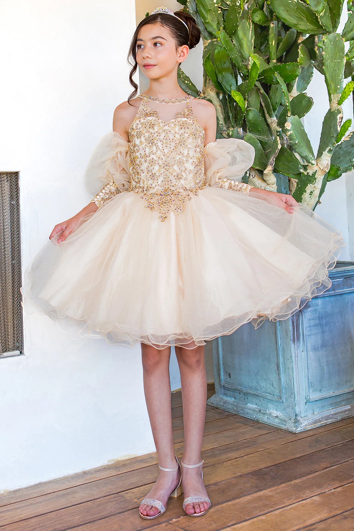 Showcasing with contrasting floral lace over the bodice, this Champagne kids party dress displays elegant detail.