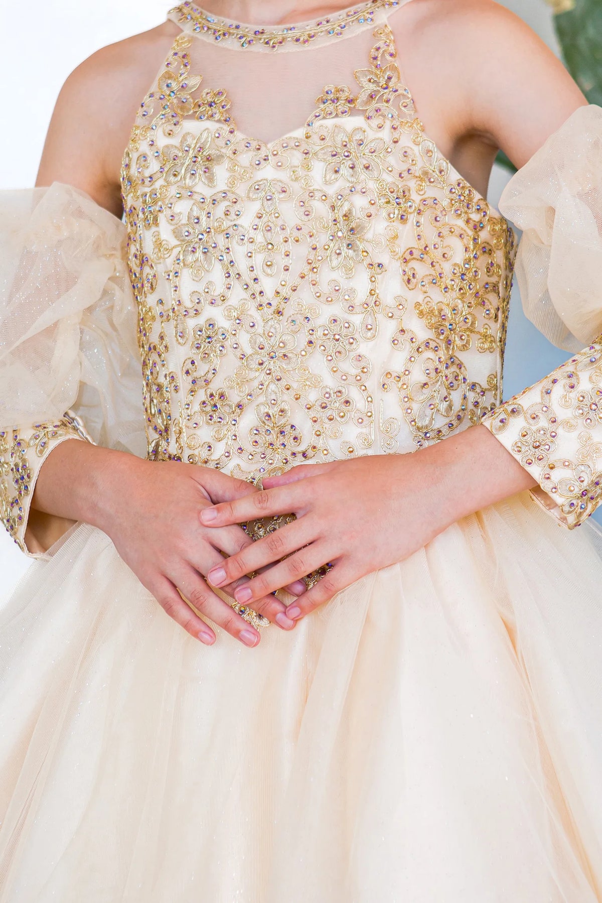 Designed details of contrasting floral lace over the bodice distinguish the Champagne kids party dress.