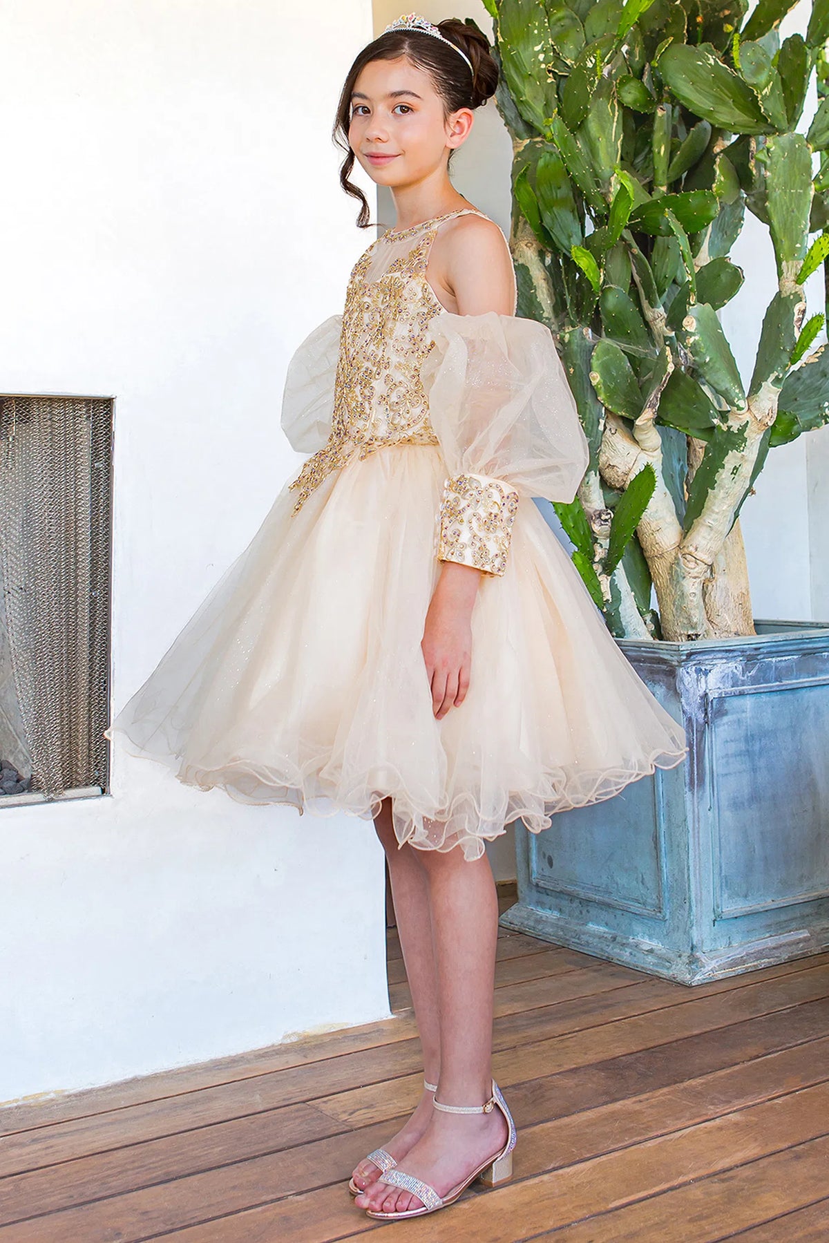 Finished details of floral lace across the back bodice distinguish the Champagne kids party dress.