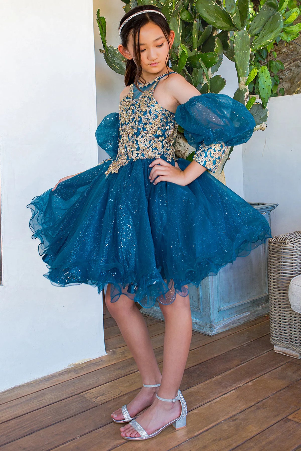 Sheer puff sleeves frame the embellished Peacock kids party dress.
