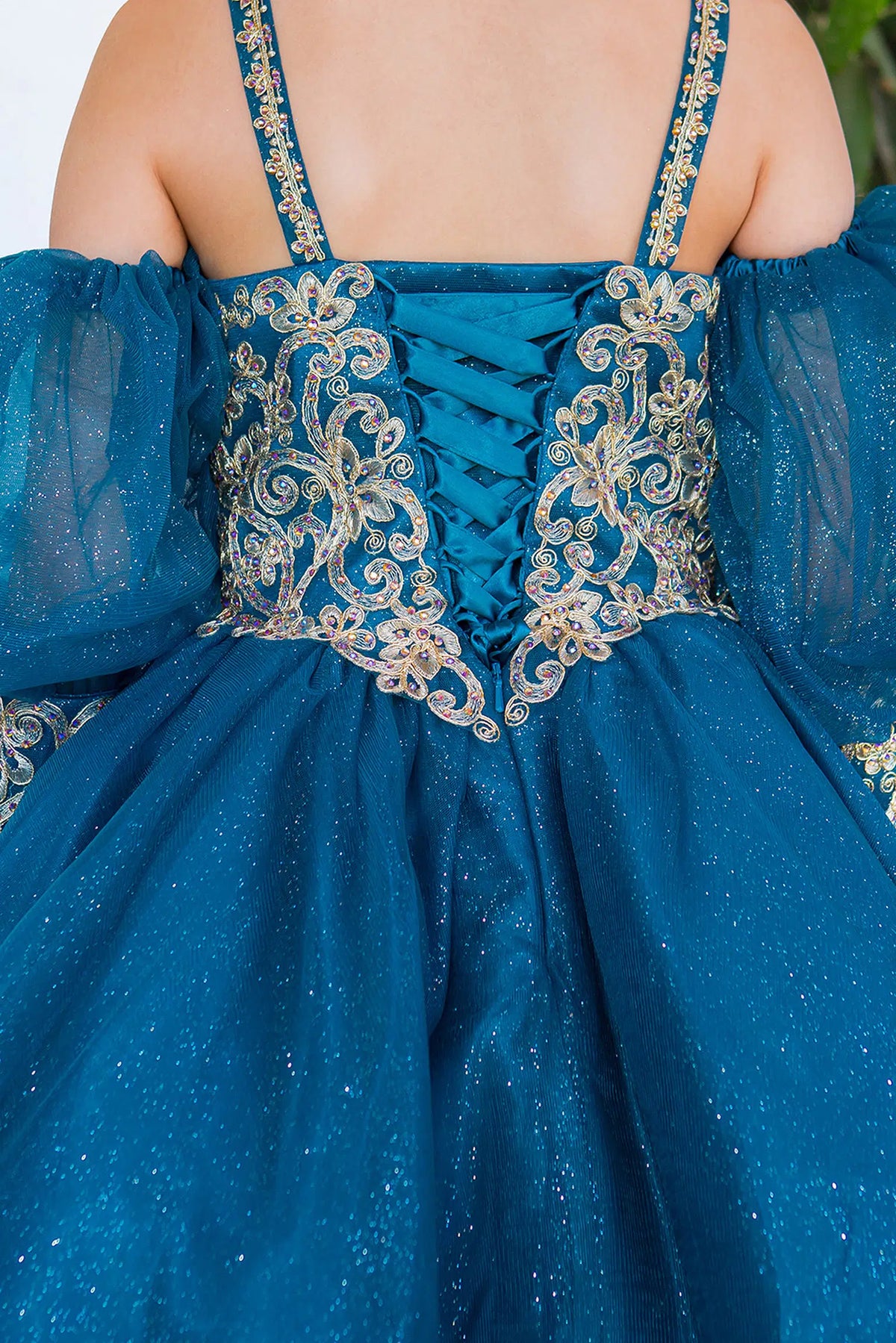 Contrasting floral scrollwork surrounds the laced back of the Peacock kids party dress.
