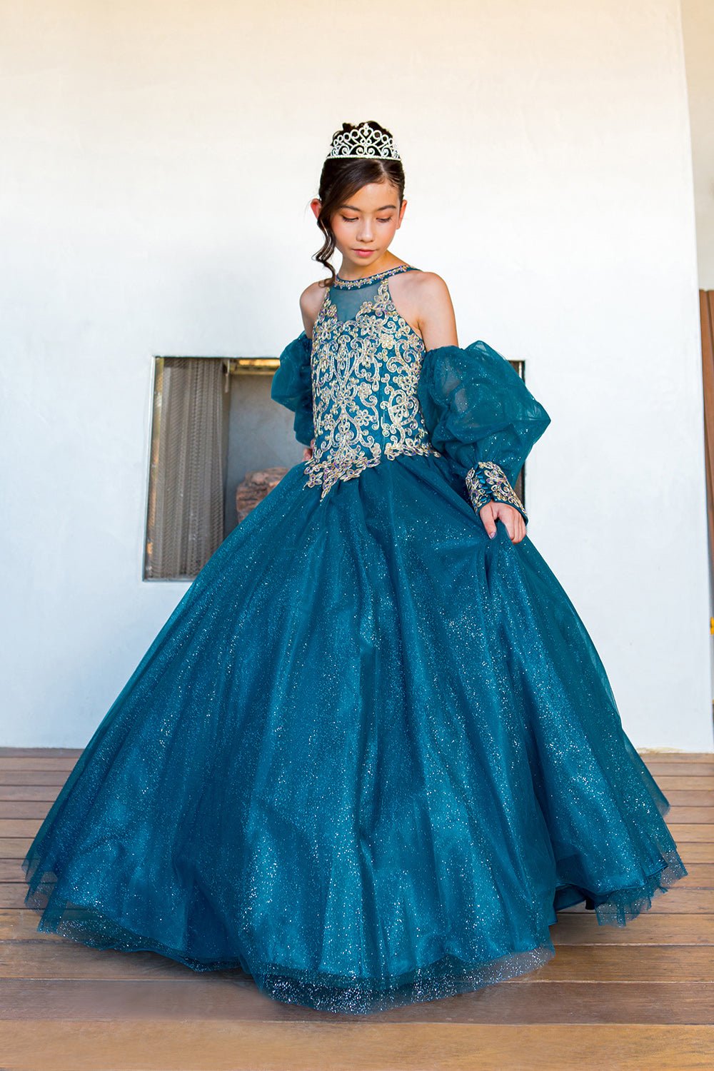 Side view of a peacock mini quince dress with glitter tulle detachable sheer puff sleeves.