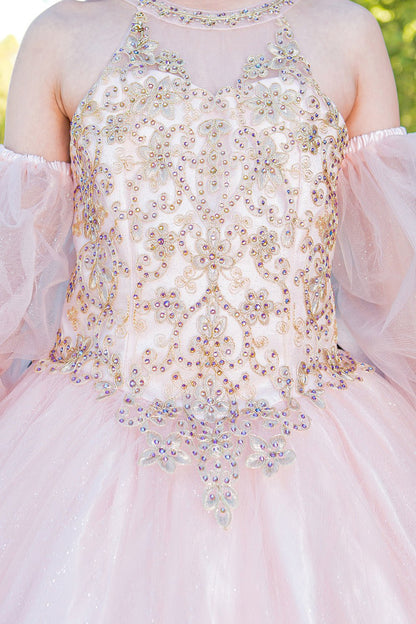 Close-up of blush mini quince dress with gold applique beading glitter tulle and layered sparkle accents