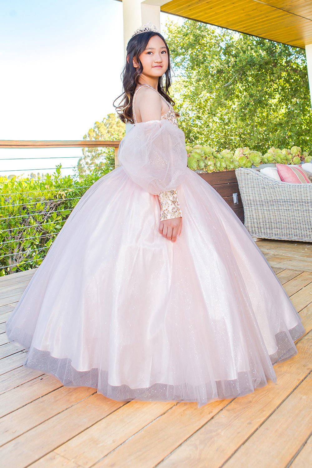 Side view of a blush mini quince dress with glitter tulle detachable sheer puff sleeves.