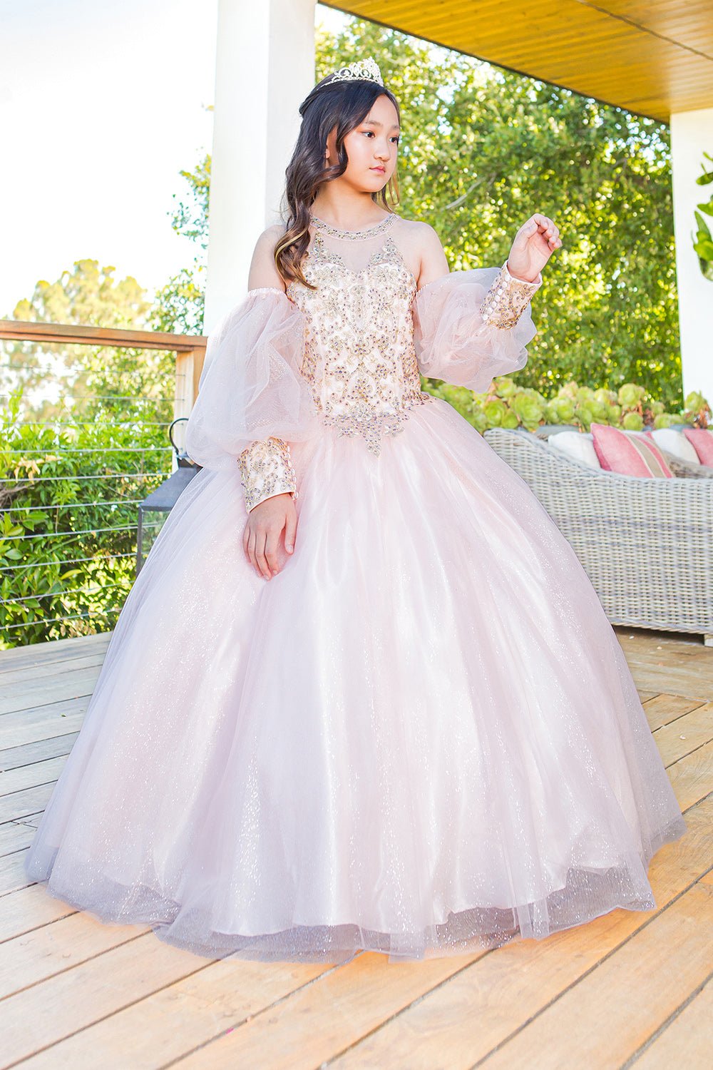 Front side view of a blush mini quince dress with glitter tulle detachable sheer puff sleeves.
