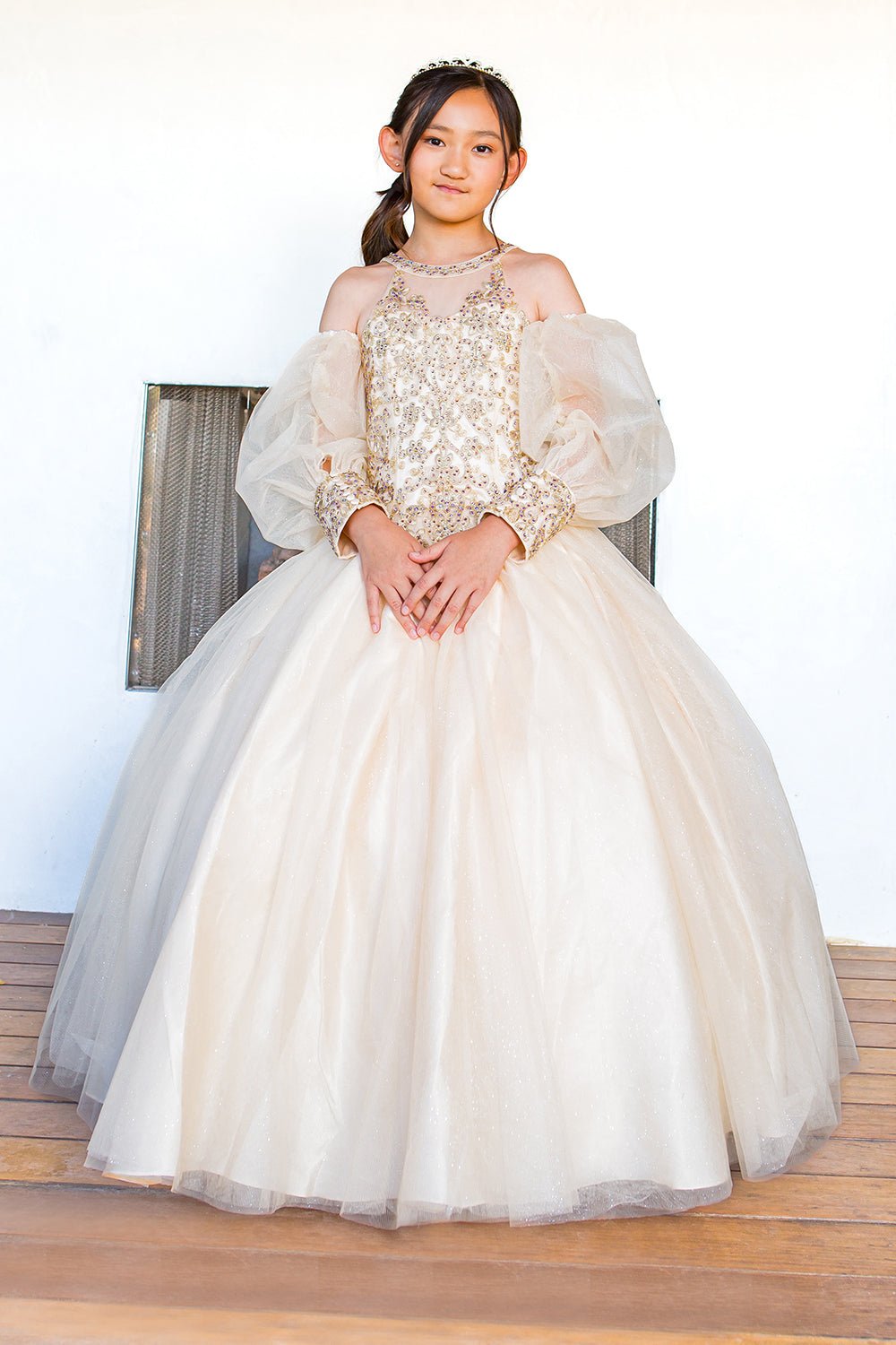 Front view of champagne mini quince dress with glitter tulle detachable sheer puff sleeves.