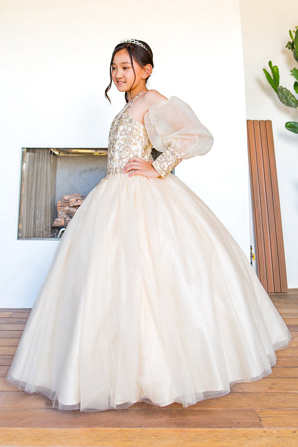 Side view of a champagne mini quince dress with glitter tulle detachable sheer puff sleeves.