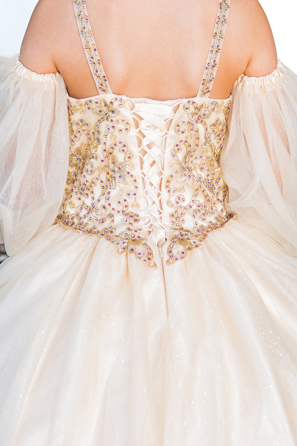 Close-up back view of champagne mini quince dress with glitter tulle detachable sheer puff sleeves and lace-up back