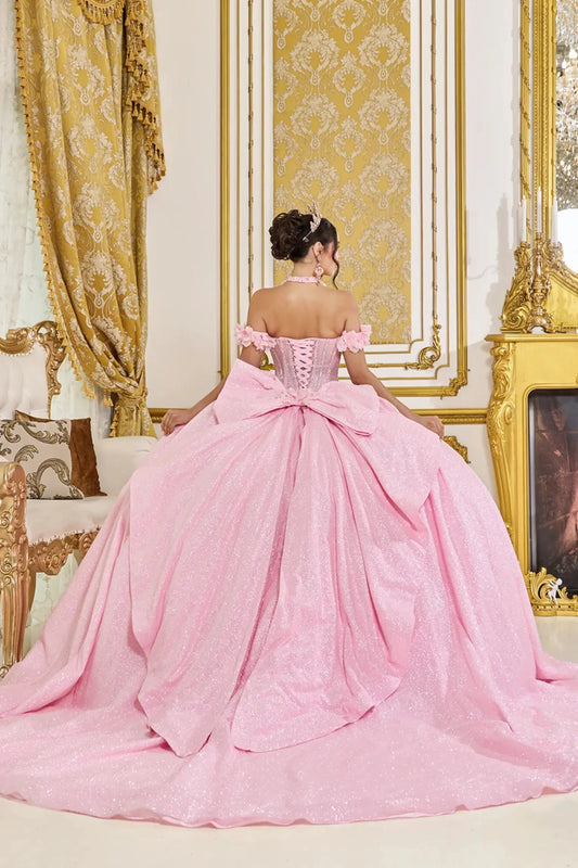 Back view of pink quinceañera ball gown featuring lace-up corset back, large detachable bow, off-the-shoulder floral straps, and voluminous glitter tulle skirt.
