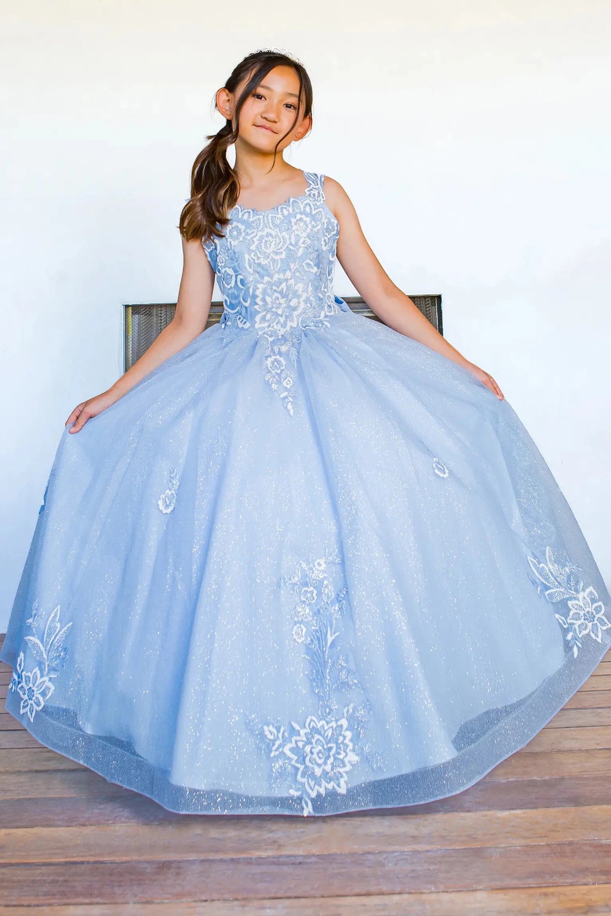 Front view of blue mini quince dress with sparkling fabric 3D flower puff print and A-line skirt.