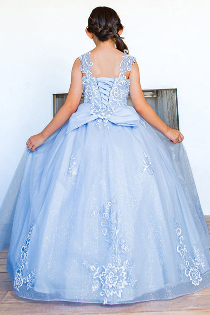 Rear view reveals blue mini quince dress with sparkling fabric 3D flower puff print and detachable back ribbon.