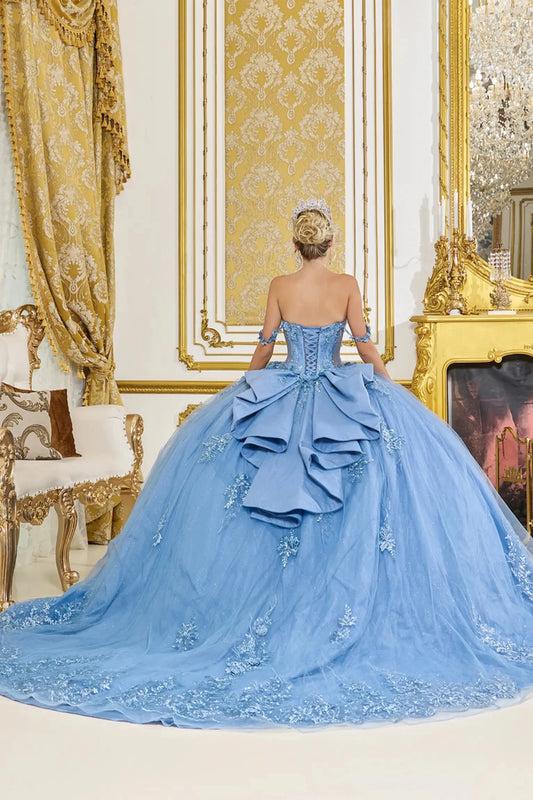 Back view of smoky blue quinceañera ball gown featuring lace-up corset back, cascading ruffle detail, and sweeping glitter tulle skirt with embroidered lace accents.
