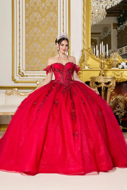 Woman in a red ball gown standing in an ornate room with gold accents.