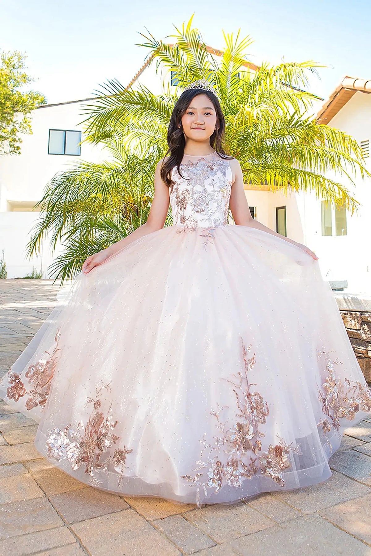 Front view of blush mini quince dress with glitter tulle fitted bodice and voluminous layered skirt.